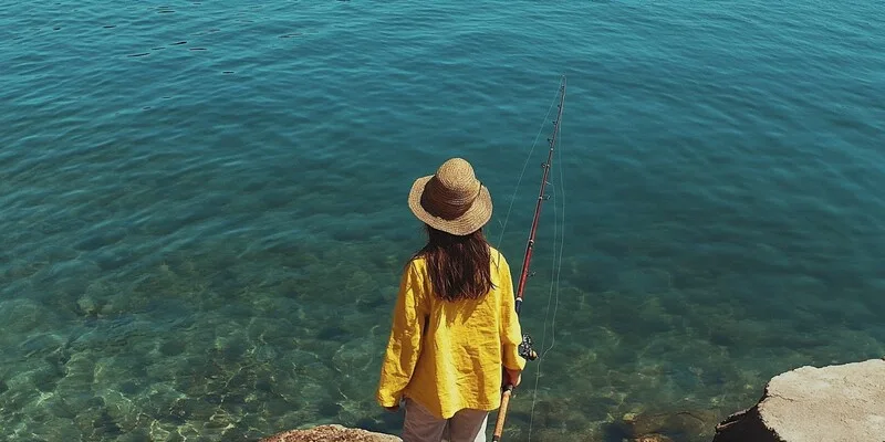 A student enjoys tranquil fishing, embracing Italian culture through language immersion