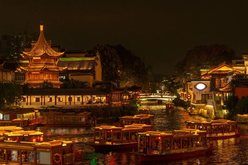Traditional Chinese architecture illuminates the night, enriching language immersion with cultural depth