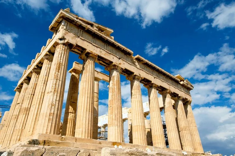 Ancient Greek architecture under blue skies enhances language immersion in Greece